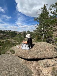 a woman sitting on top of a large rock at Dream house in Türgen