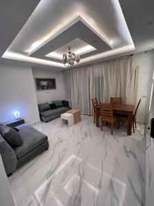 a large living room with a table and a couch at Porto sokhna pyramids in Ain Sokhna