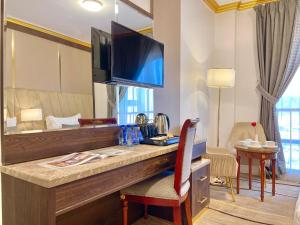a hotel room with a desk with a large mirror at ODST AL Madinah Hotel - فندق اودست المدينة in Medina