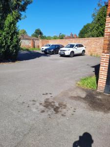 a shadow of a parking lot with cars parked at The Bugle Hotel in Titchfield
