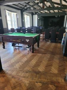 a pool table in a room with chairs at The Bugle Hotel in Titchfield