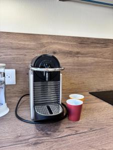 a coffee maker sitting on top of a table at Le Studio Côté Cour in Oberbetschdorf