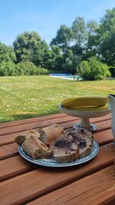 a plate of bread sitting on a table with a plate of food at Domaine de Chaunac in Chaunac