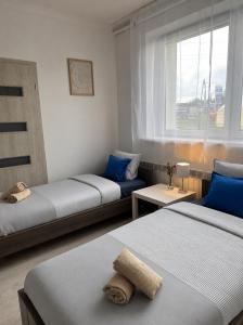 a small room with two beds and a window at Aura Poręba Żegoty in Poręba Żegoty