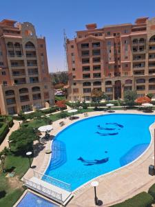 a large swimming pool in front of some buildings at Marina Valley El Alamein in El Alamein