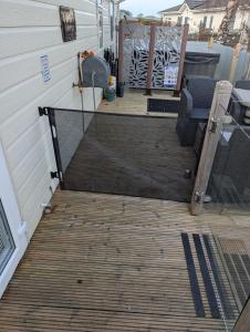 a screened in porch with a wooden deck at 21 Hesket Park HUGE HOT TUB Pet friendly No Commercial Vans in High Hesket