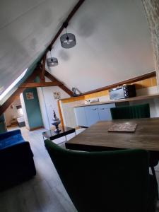 a kitchen and dining room with a table and chairs at Chez Cosette, studio in Montreuil-sur-Mer