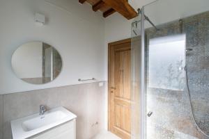 a bathroom with a shower and a sink and a mirror at Peaceful Umbria views & heated infinity pool in Umbertide +26 photos
