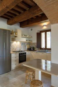 a kitchen with a stainless steel refrigerator and a counter at Peaceful Umbria views & heated infinity pool in Umbertide