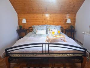 a bed with a table with two glasses on it at Kuća za odmor Lipa Dora near Plitvice in Donji Babin Potok