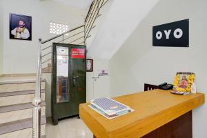 a room with a wooden table and a green door at Hotel O SSR residency in Venjāramūdu