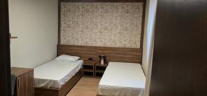 a small room with two beds and a desk at Drei Schweizer Hotel 201 in Neuwied
