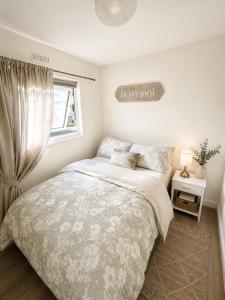 a bedroom with a bed and a window at 18 river view chalet-Glan Gwna Holiday Park in Caernarfon +5 photos