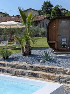 a palm tree sitting next to a swimming pool at Corte Furmignano in Solto Collina