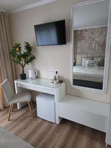 a bedroom with a white desk and a mirror at APARTAMENTI BrivdienuKolka in Kolka