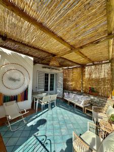 a patio with a wooden ceiling and a table and chairs at Capri Joy Apartments in Capri