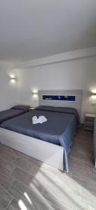 a bedroom with a large bed with a blue blanket at Sabry holiday Terrasini in Terrasini +67 photos