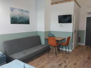 a living room with a couch and a table at WINNICA 61 - Pokoje in Krotoszyce