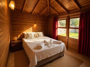a bedroom with a bed in a wooden room at Denge Hidden Garden in İslâmlar