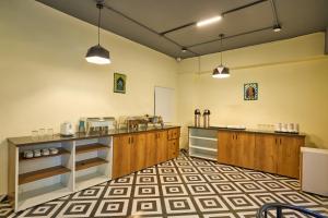 a large kitchen with wooden cabinets and a counter at Treebo Cultura in Hyderabad +40 photos