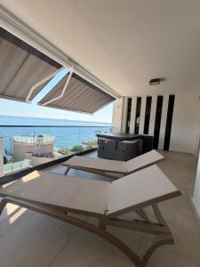 a kitchen with a table and a view of the ocean at AdAstra Apartments in Maslenica