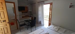 a room with a bed and a table and a kitchen at Beach Side Apartments in Drepana +32 photos