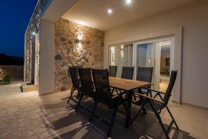 a dining room with a table and chairs at Villa Lapidea in Vodice