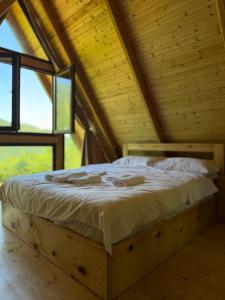 a bed in the attic of a wooden house at Guri's hut in Kirnat'i