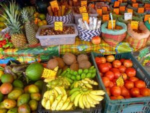 a display of fruits and vegetables on a market at Le Coeur des Iles in Sainte-Anne