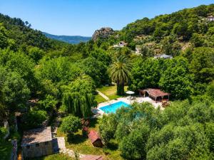 an aerial view of a villa with a swimming pool and trees at Denge Hidden Garden in İslâmlar