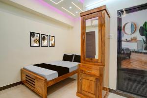 a small bedroom with a bed and a mirror at Hotel O SSR residency in Venjāramūdu