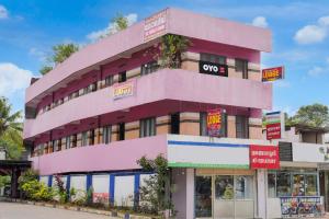 a pink building on the side of a street at Hotel O SSR residency in Venjāramūdu +21 photos