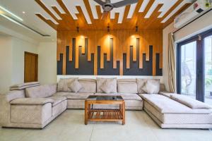 a living room with a couch and a table at Treebo Cultura in Hyderabad
