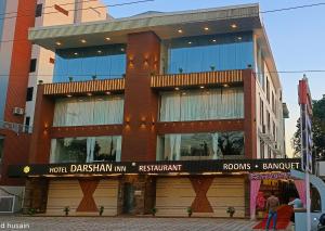 a building with a sign on the front of it at Hotel Darshan Inn in Anand