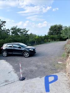 a black car parked on the side of a road at B&B Bellaria Rooms in Longbardi