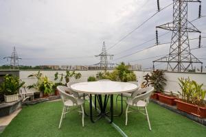 a patio with a table and chairs on a balcony at Treebo Cultura in Hyderabad