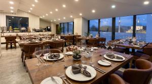 a restaurant with wooden tables and chairs and windows at Istanbul Midpoint Hotel in Istanbul