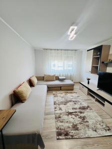 a living room with a couch and a tv at Imperium DK Apartament in Giurgiu