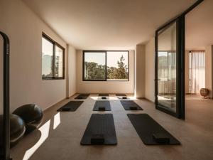 a yoga room with a row of yoga mats at Besai Ibiza Boutique Hotel - New Opening in San Jose