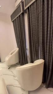 a bathroom with two toilets and a shower at Greenwich Garden in Onisigun
