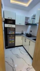 a kitchen with a black stove top oven at Greenwich Garden in Onisigun