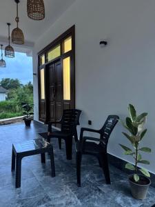 a living room with two chairs and a table at Villa Calista Weligama in Weligama
