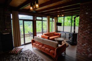a living room with a couch and a fireplace at Gafulluk Tatil Köyü in Araklı