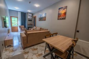 a living room with a couch and a table at Demirkapı Otel in Uzungöl