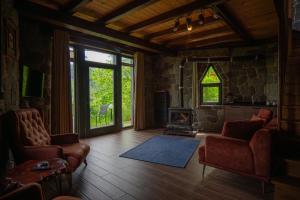 a living room with a couch and a fireplace at Gafulluk Tatil Köyü in Araklı