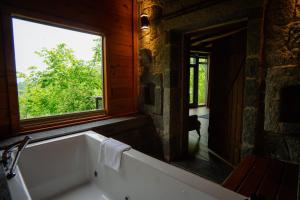 a bathroom with a bath tub and a window at Gafulluk Tatil Köyü in Araklı +183 photos