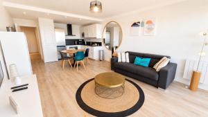 a living room with a couch and a table at Les Baux 1 in Sanary-sur-Mer