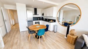 a kitchen and dining room with a table and a mirror at Les Baux 1 in Sanary-sur-Mer