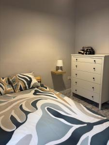 a bedroom with a bed and a white dresser at El Volcan in Los Llanillos