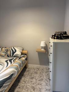 a bedroom with a bed and a table with a lamp at El Volcan in Los Llanillos